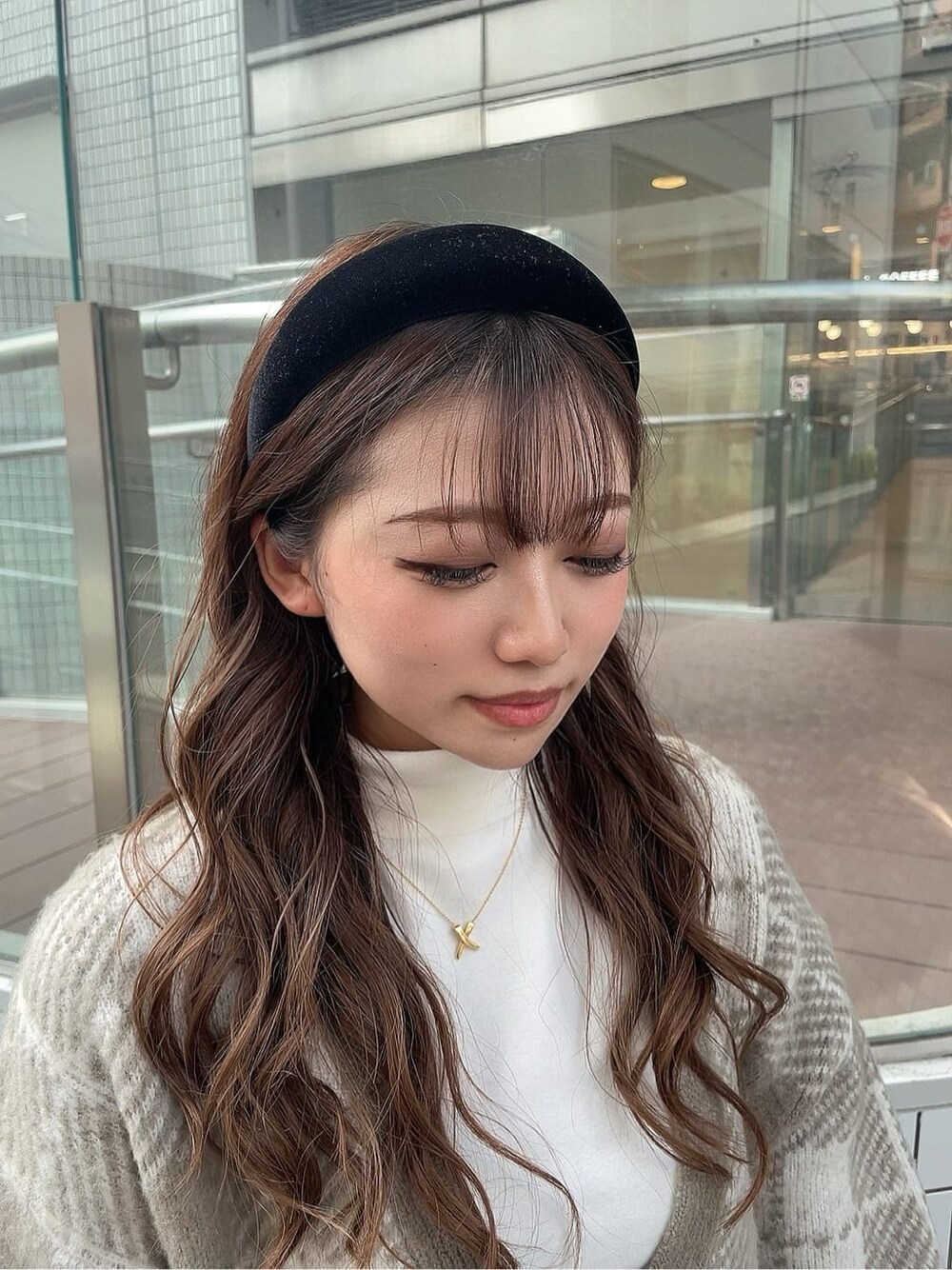 ブラック系のスカート、ホワイト系のTシャツ/カットソー、ブラック系のブーツを着用したレディースの秋コーディネートの5枚目の写真