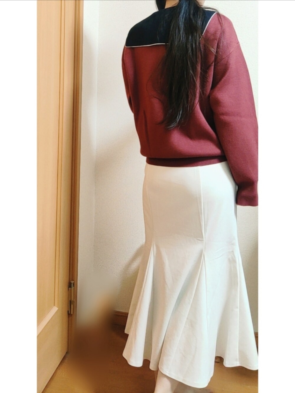 ホワイト系のスカート、レッド系のニット/セーター、ブラック系のシャツ/ブラウスを着用したレディースの冬コーディネートの2枚目の写真