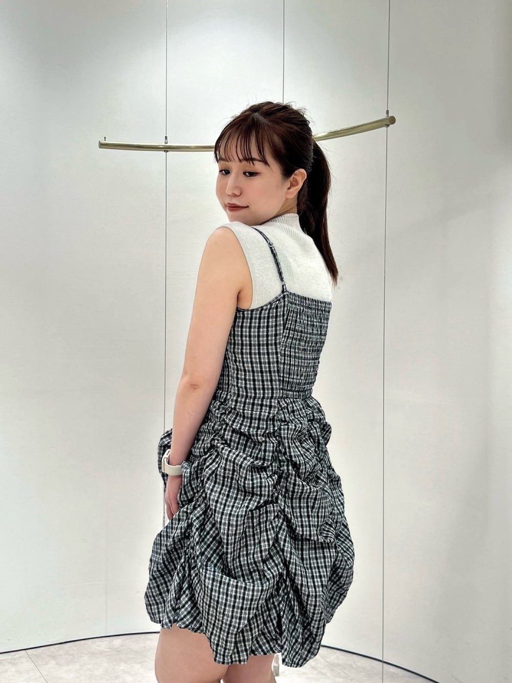 グレー系のワンピース、ホワイト系のニット/セーター、ホワイト系のサンダルを着用したレディースの夏コーディネートの7枚目の写真