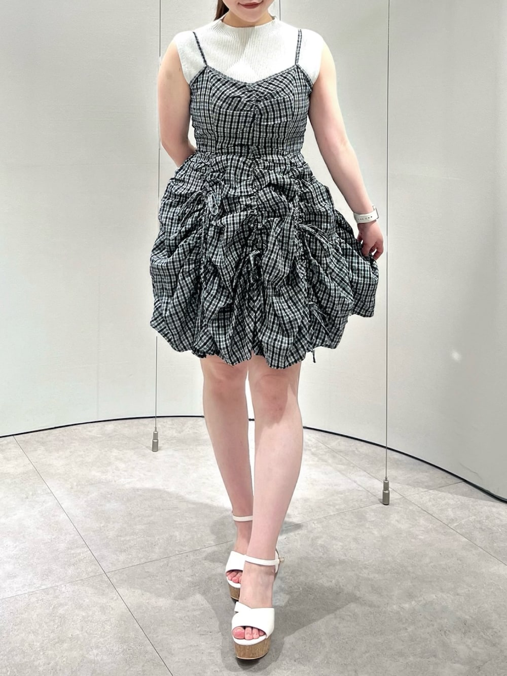 グレー系のワンピース、ホワイト系のニット/セーター、ホワイト系のサンダルを着用したレディースの夏コーディネートの2枚目の写真