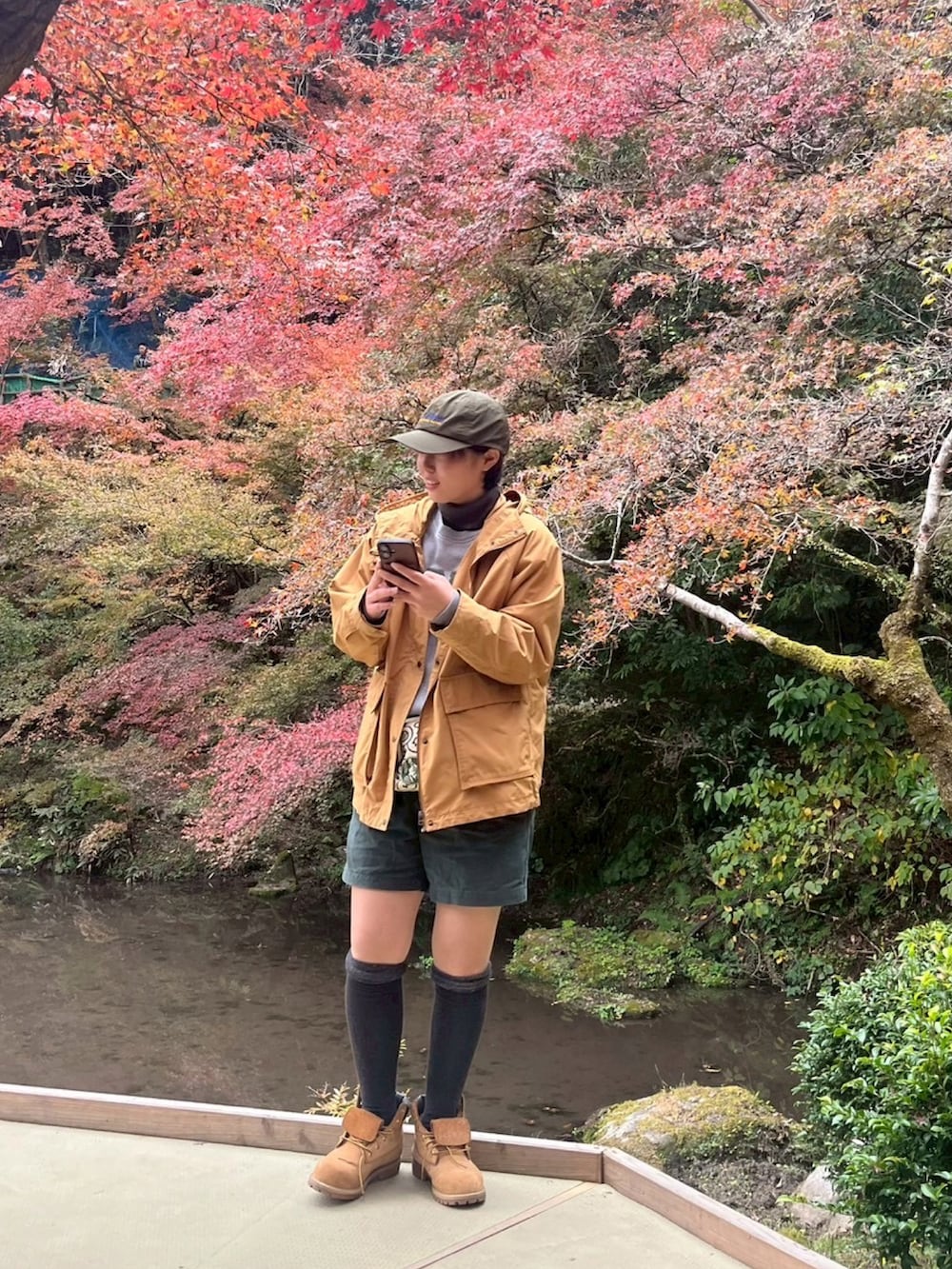 ブラウン系のブーツ、グレー系のスウェット、グリーン系のキャップを着用したレディースの秋コーディネートの3枚目の写真