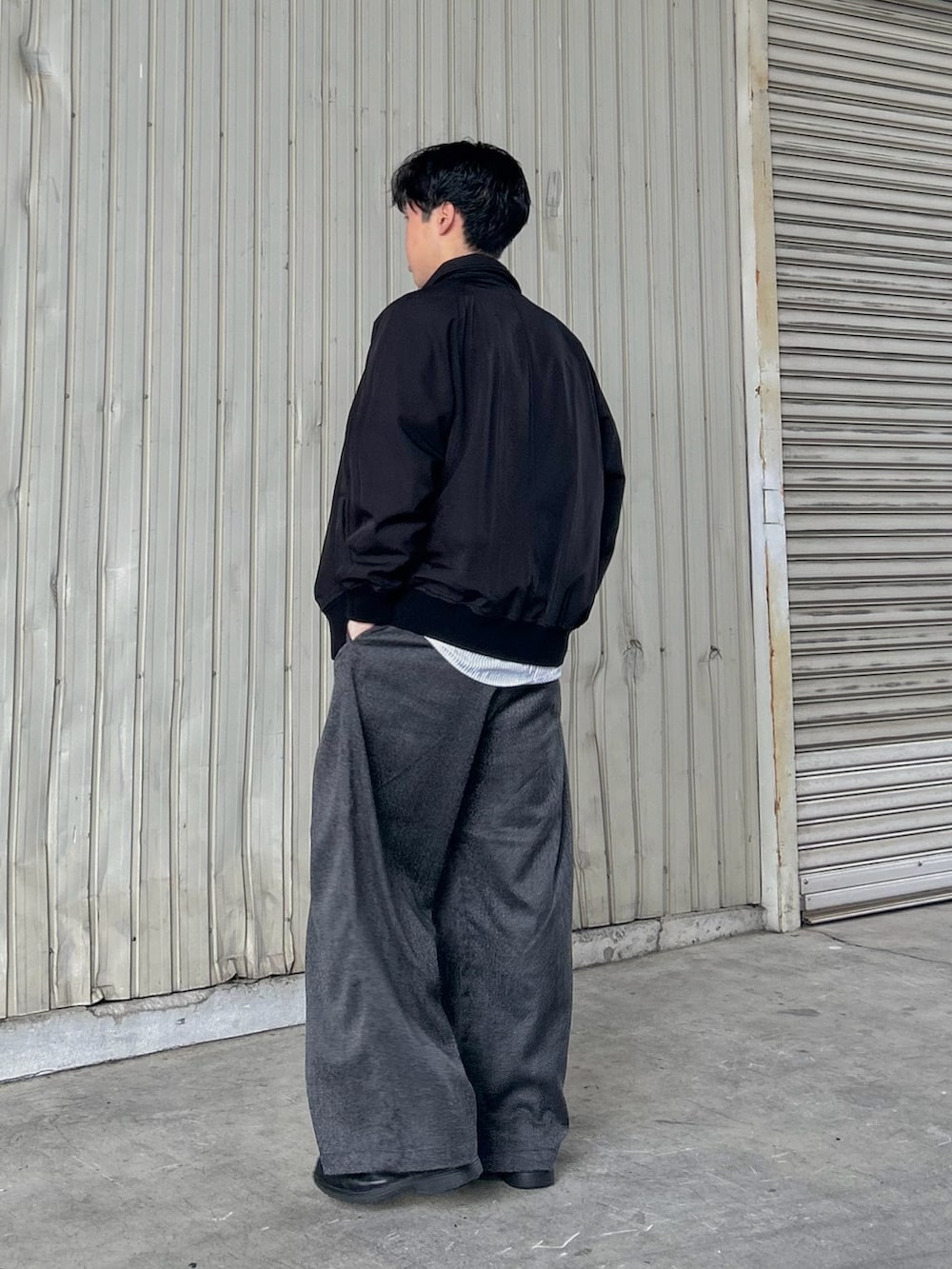 グレー系のシャツ/ブラウス、ブラック系のスラックス、ブラック系のシューズを着用したメンズの秋コーディネートの3枚目の写真