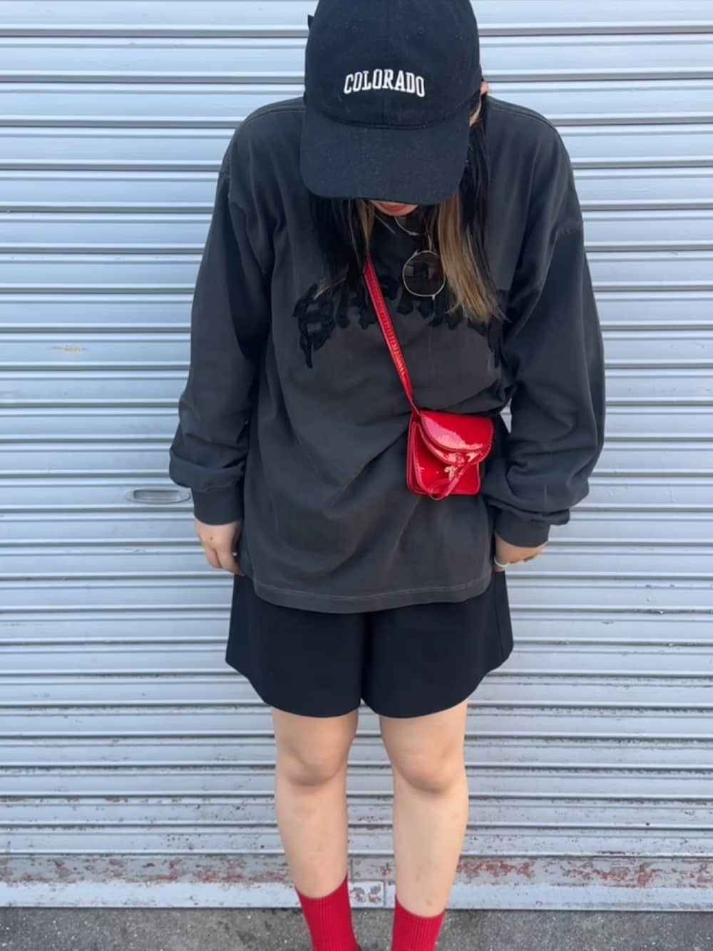 ブラック系のTシャツ/カットソー、ブラック系のその他パンツ、レッド系のショルダーバッグを着用したレディースの秋コーディネートの2枚目の写真