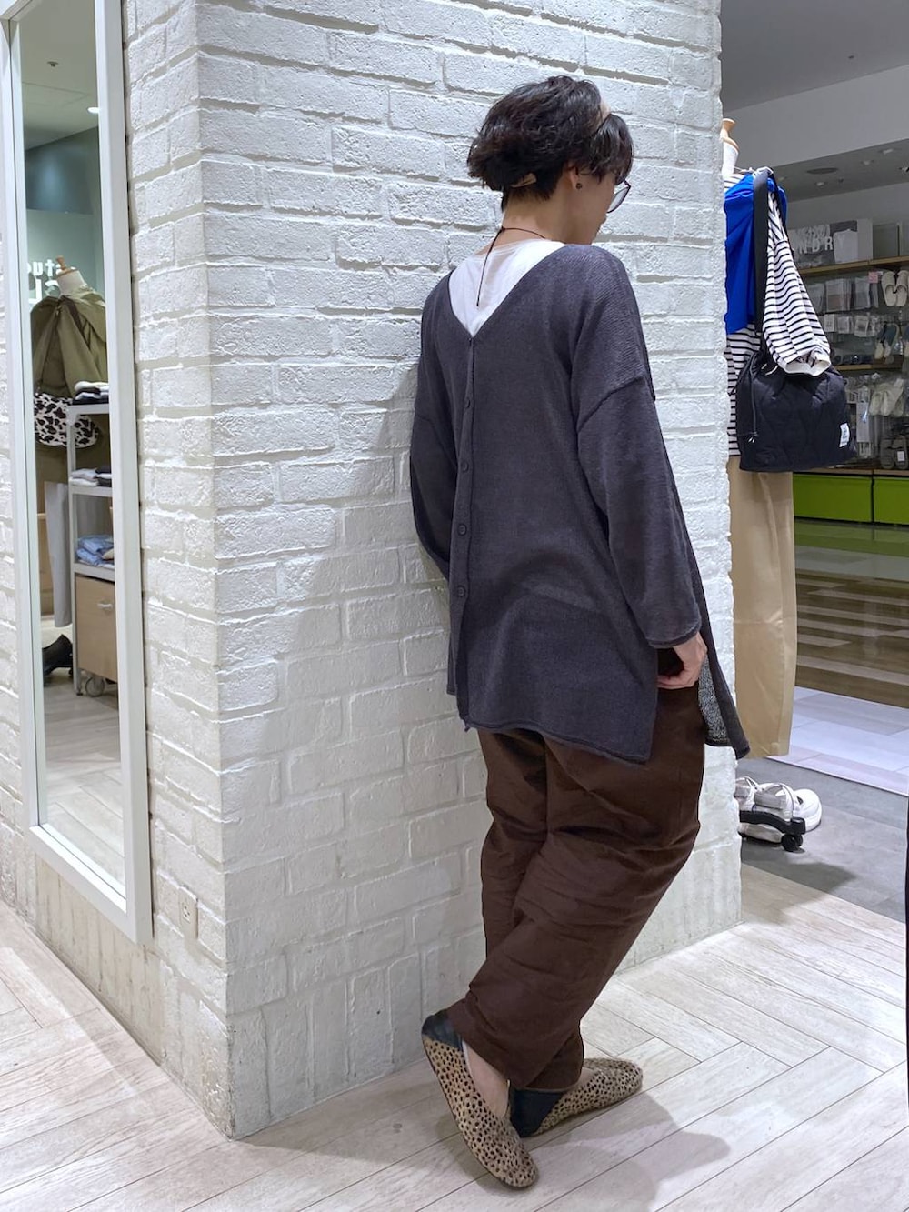 ホワイト系のTシャツ/カットソー、ブラウン系のその他パンツ、グレー系のカーディガン/ボレロを着用したレディースの春コーディネートの6枚目の写真