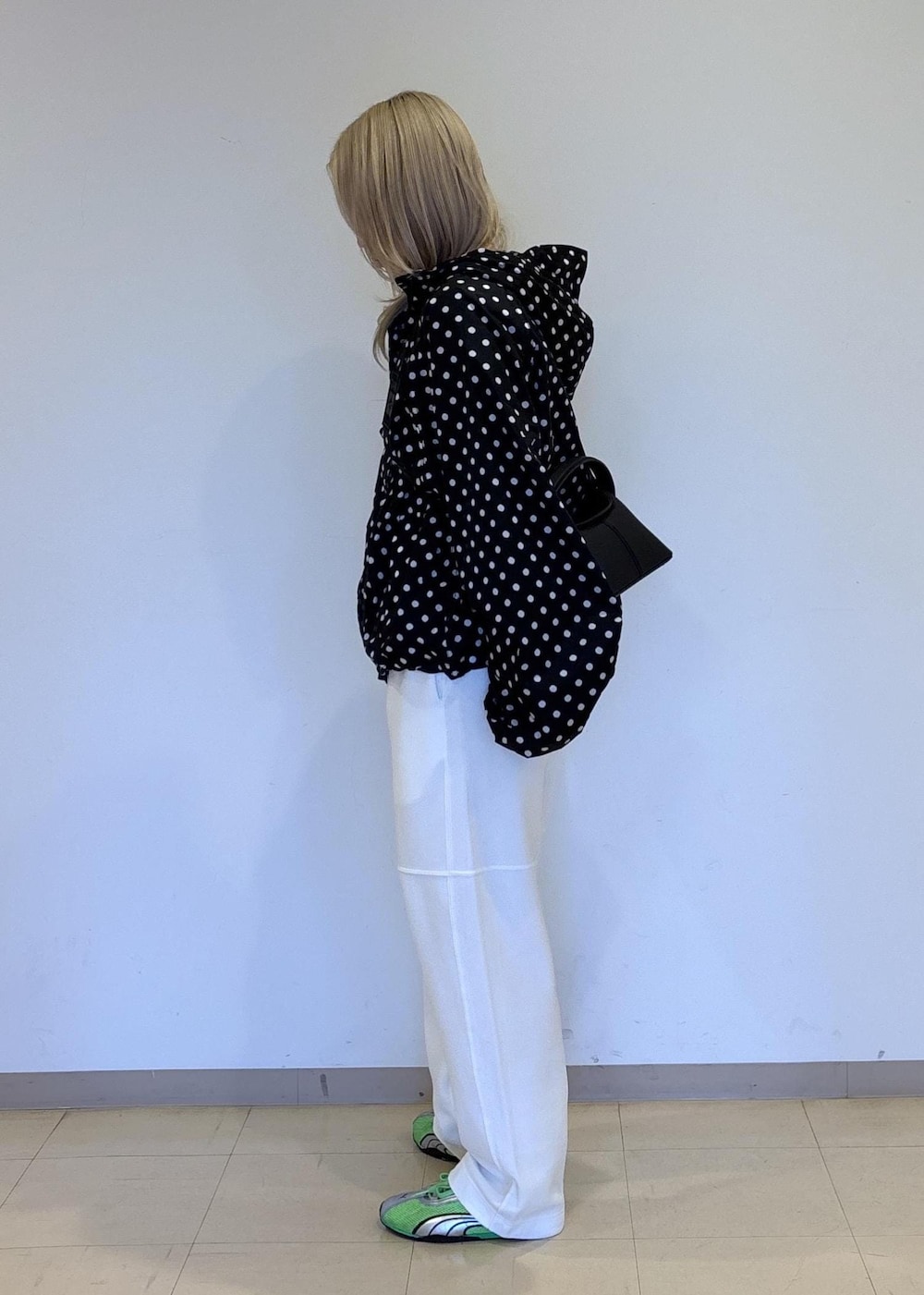 ホワイト系のその他パンツ、ブラック系のナイロンジャケットを着用したレディースの春コーディネートの2枚目の写真