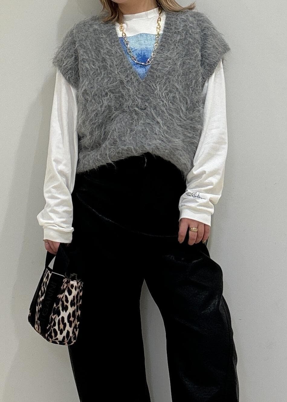 ベージュ系のトートバッグ、ホワイト系のTシャツ/カットソー、グレー系のニット/セーターを着用したレディースの秋コーディネートの5枚目の写真