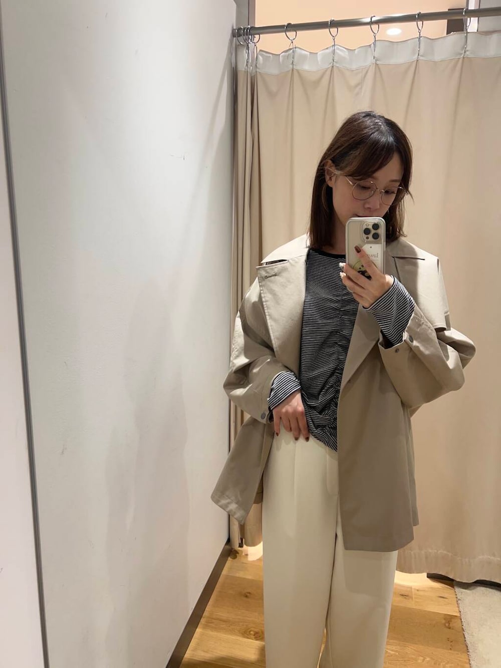 ホワイト系のその他パンツ、ベージュ系のトレンチコート、ホワイト系のTシャツ/カットソーを着用したレディースの冬コーディネートの3枚目の写真