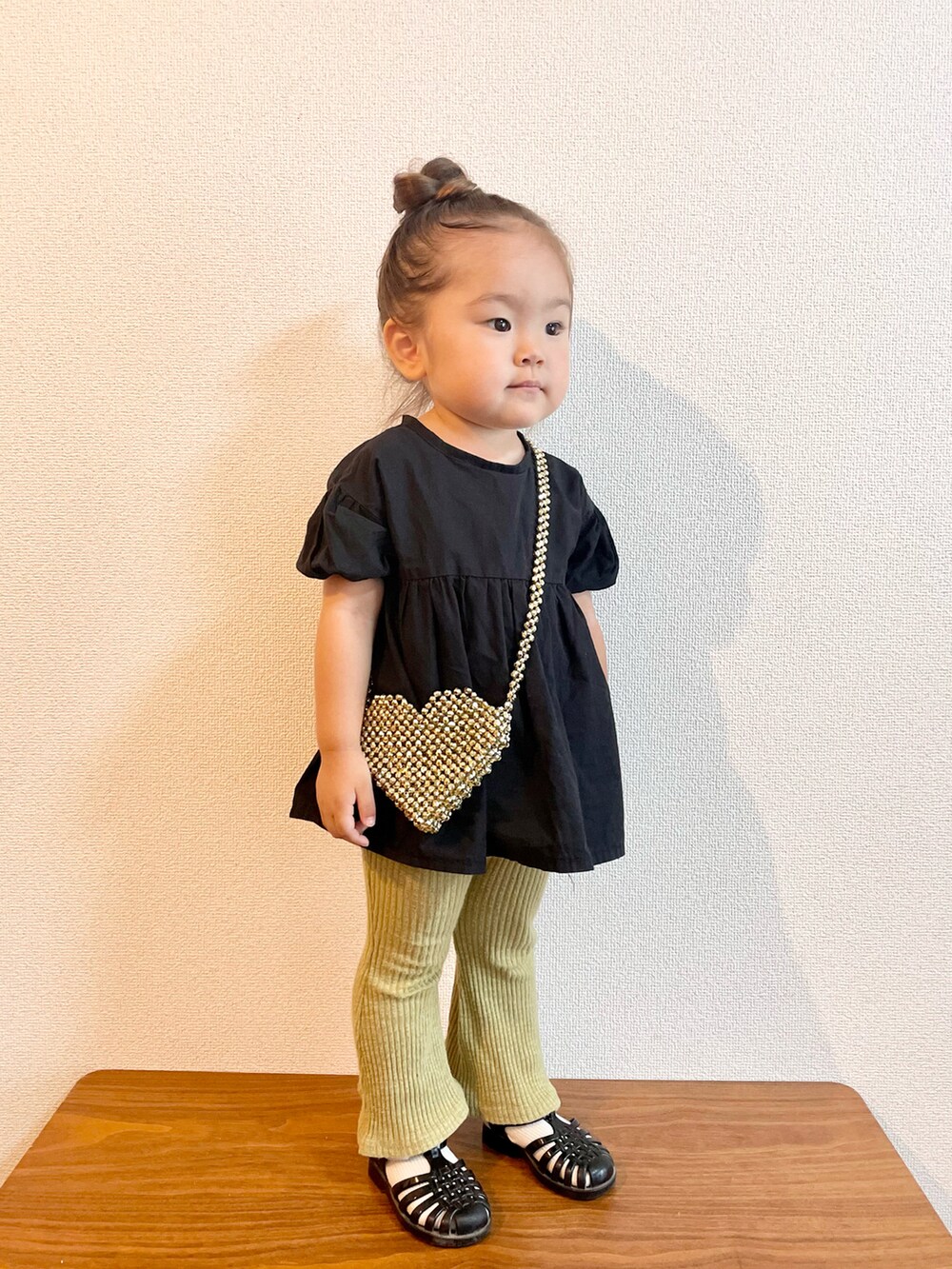 ブラック系のシャツ/ブラウス、ゴールド系のショルダーバッグ、グリーン系のその他パンツを着用したキッズの夏コーディネートの2枚目の写真