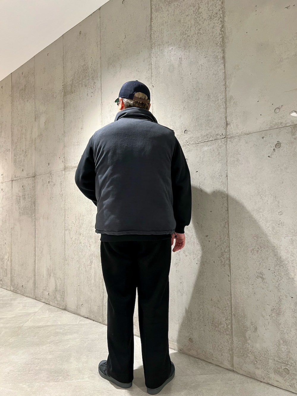 グリーン系のダウンベスト、ブラック系のその他パンツ、ブラック系のスウェットを着用したメンズの秋コーディネートの5枚目の写真