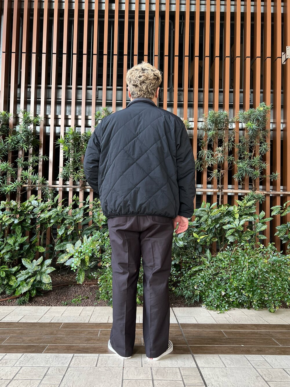 ブラック系のその他パンツ、ブラック系のスニーカー、ホワイト系のTシャツ/カットソーを着用したメンズの秋コーディネートの5枚目の写真