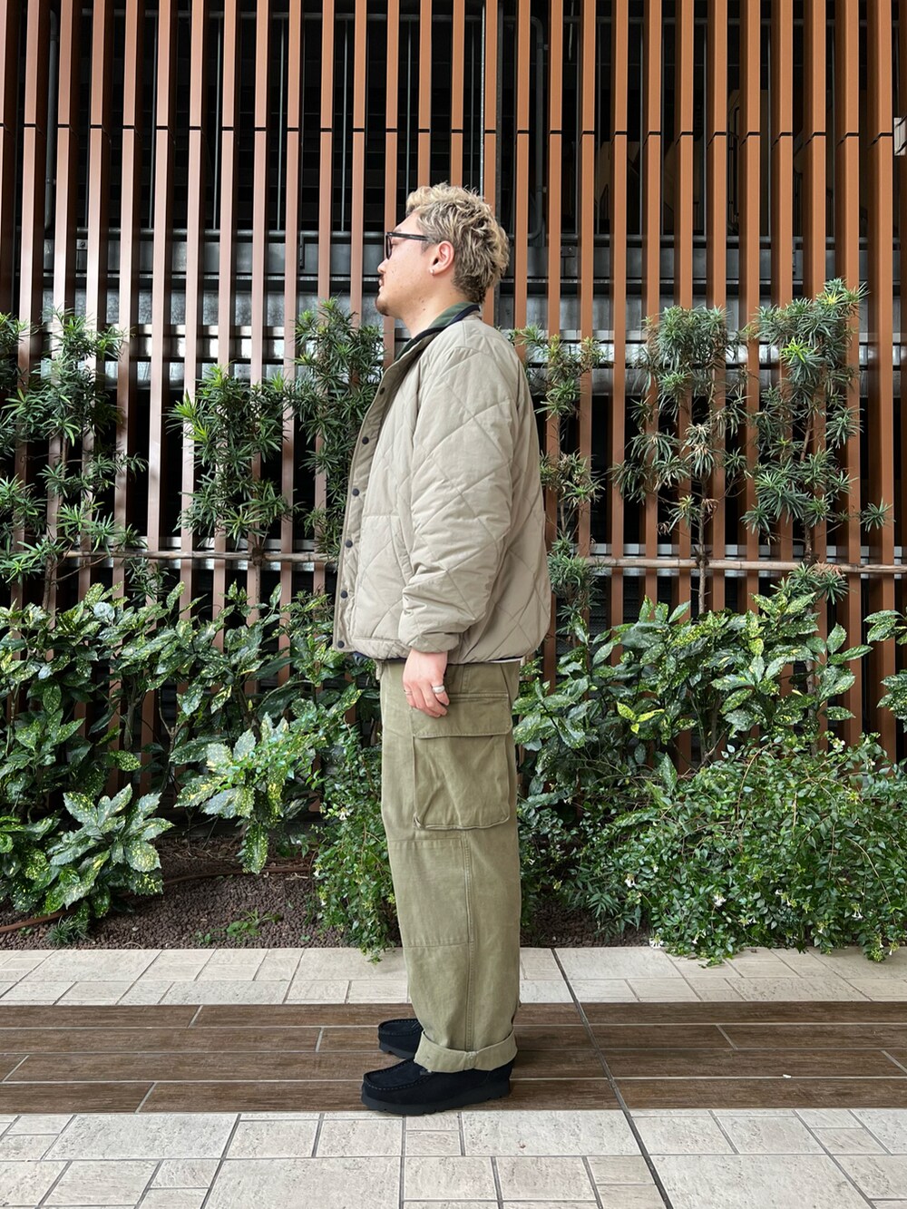 ベージュ系のブルゾン、ホワイト系のTシャツ/カットソー、グリーン系のカーゴパンツを着用したメンズの冬コーディネートの2枚目の写真
