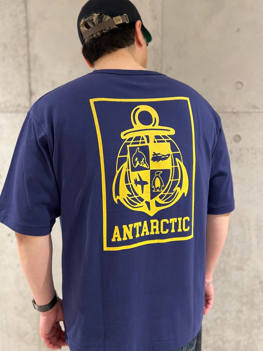 ブルー系のTシャツ/カットソー、ブルー系のデニムパンツ、レッド系のモカシン/デッキシューズを着用したメンズの春コーディネートの4枚目の写真