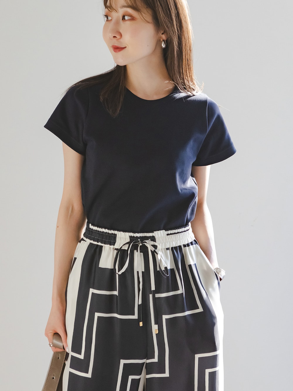 ブルー系のTシャツ/カットソー、ブルー系のその他パンツ、ブラウン系のショルダーバッグを着用したレディースの春コーディネートの4枚目の写真