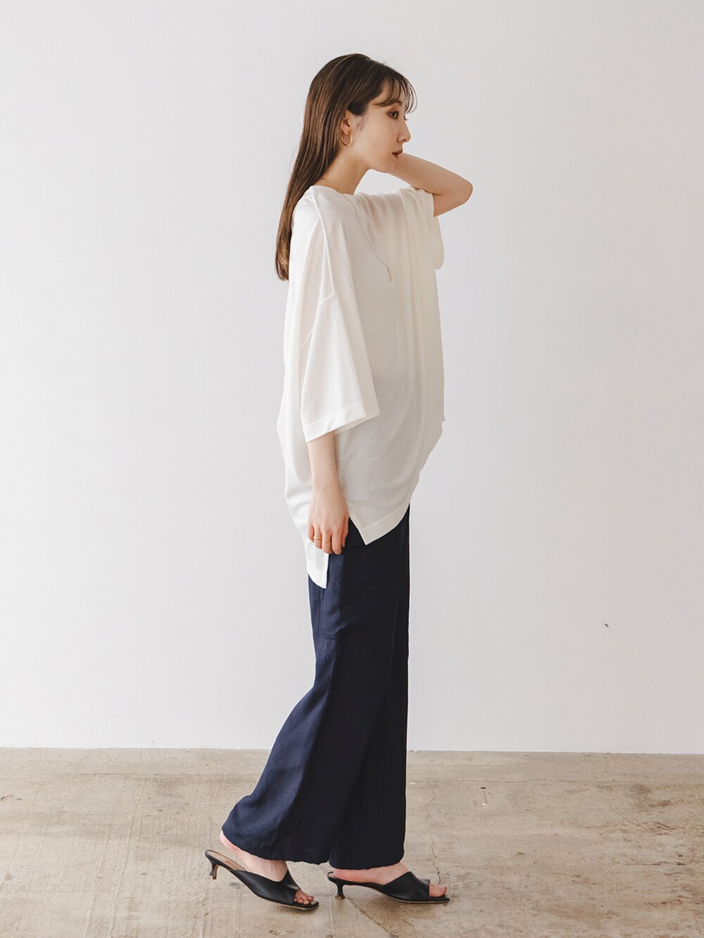 ホワイト系のTシャツ/カットソー、ブルー系のカーゴパンツ、ブラック系のサンダルを着用したレディースの春コーディネートの2枚目の写真