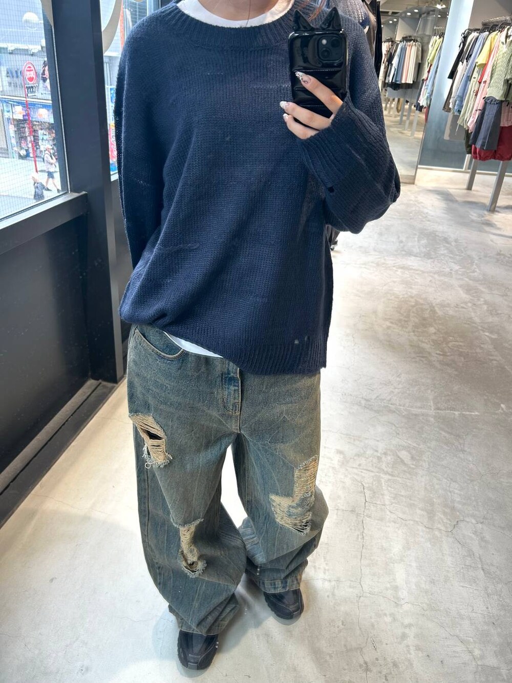 ブルー系のニット/セーター、ブルー系のデニムパンツを着用したレディースの秋コーディネートの2枚目の写真