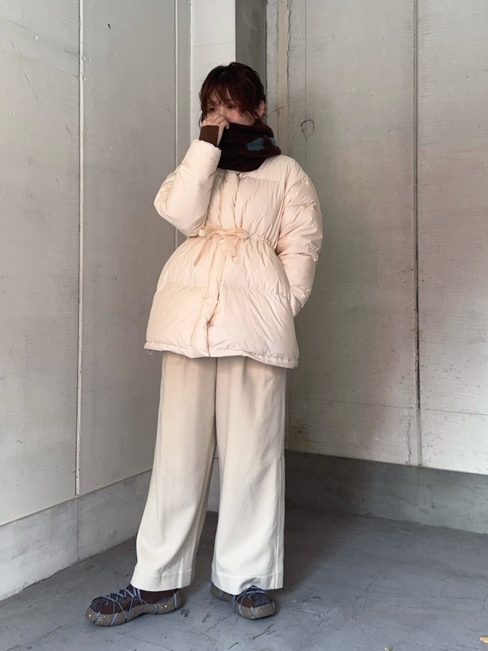 ブラウン系のスニーカー、ブラウン系のマフラーを着用したレディースの冬コーディネートの8枚目の写真