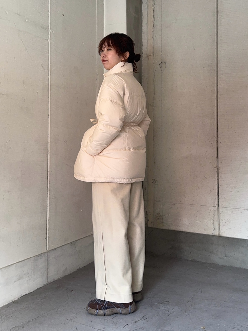 ブラウン系のスニーカー、ブラウン系のマフラーを着用したレディースの冬コーディネートの2枚目の写真