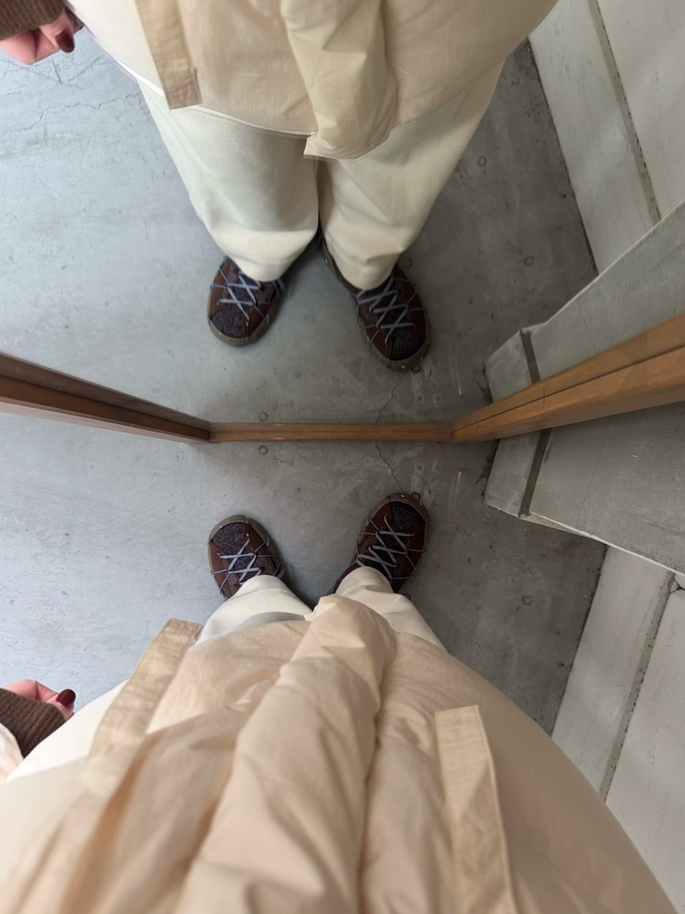 ブラウン系のスニーカー、ブラウン系のマフラーを着用したレディースの冬コーディネートの6枚目の写真