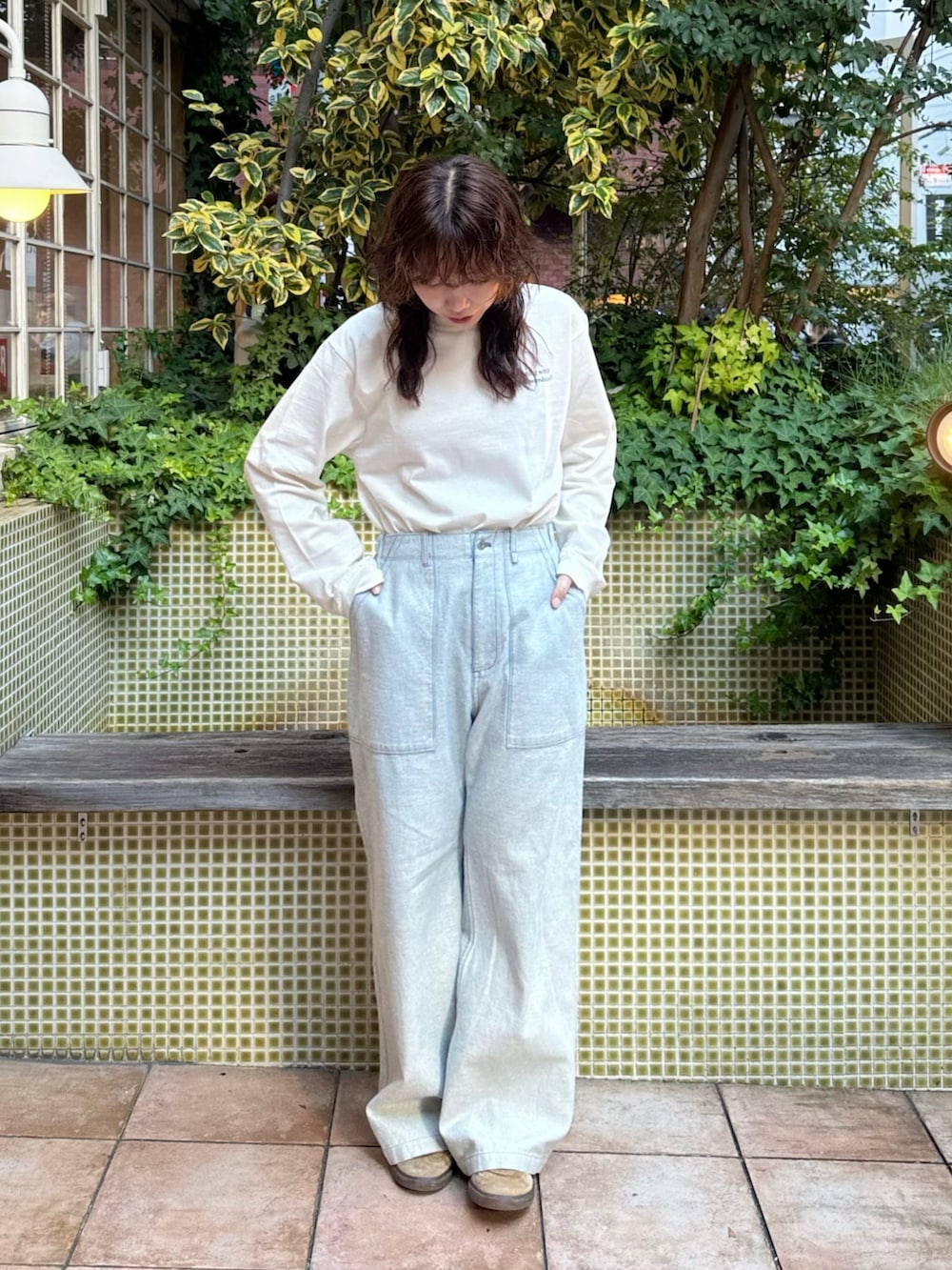 ブルー系のデニムパンツを着用したレディースの秋コーディネートの3枚目の写真