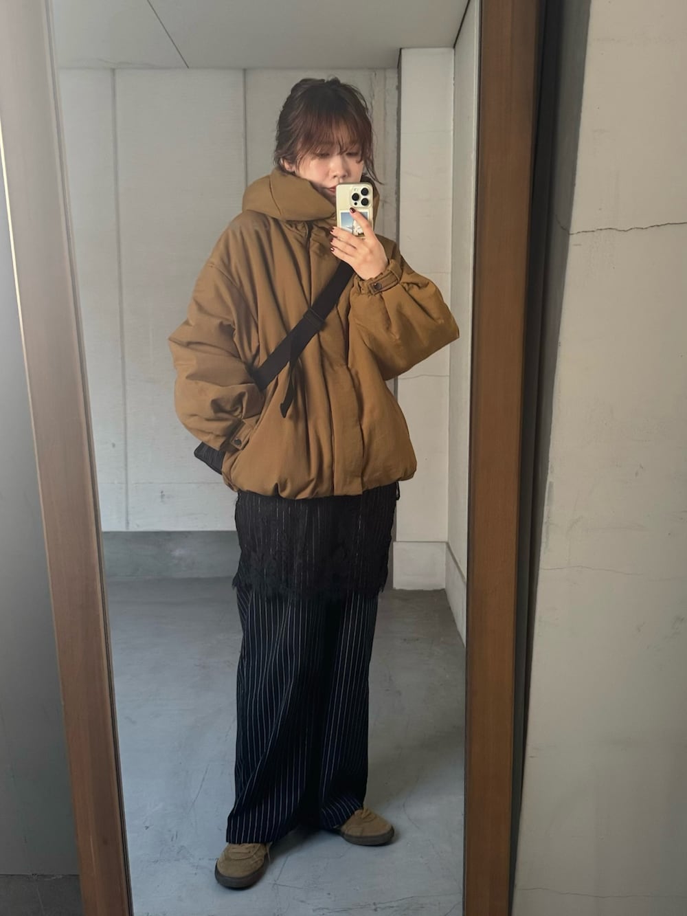 グリーン系のブルゾン、ブラック系のその他パンツ、ブラック系のショルダーバッグを着用したレディースの冬コーディネートの4枚目の写真