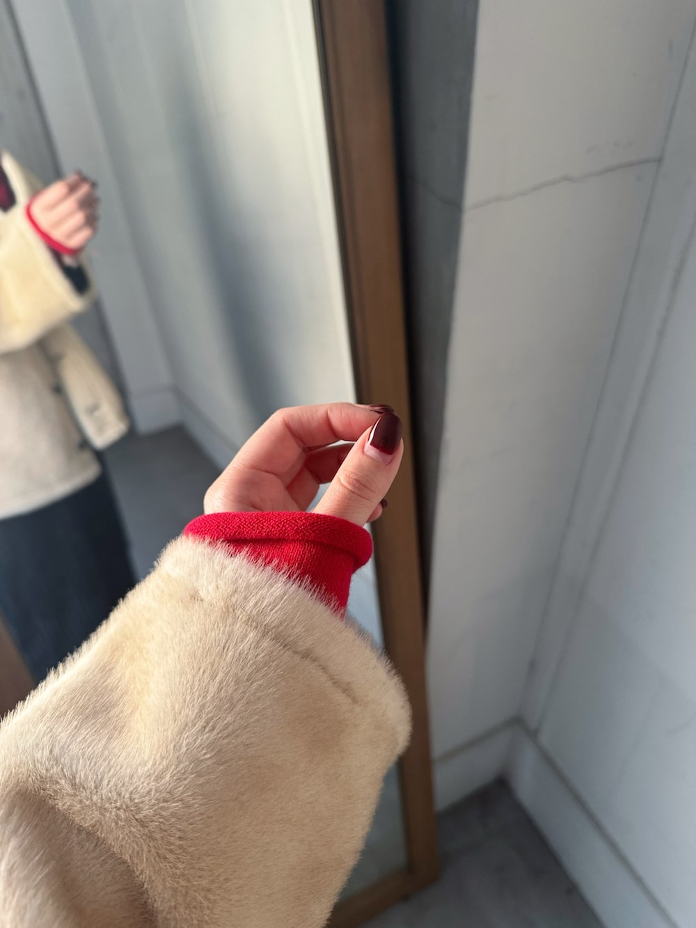 ブラック系のテーラードジャケット、レッド系のカーディガン/ボレロ、ブラック系のその他パンツを着用したレディースの冬コーディネートの4枚目の写真