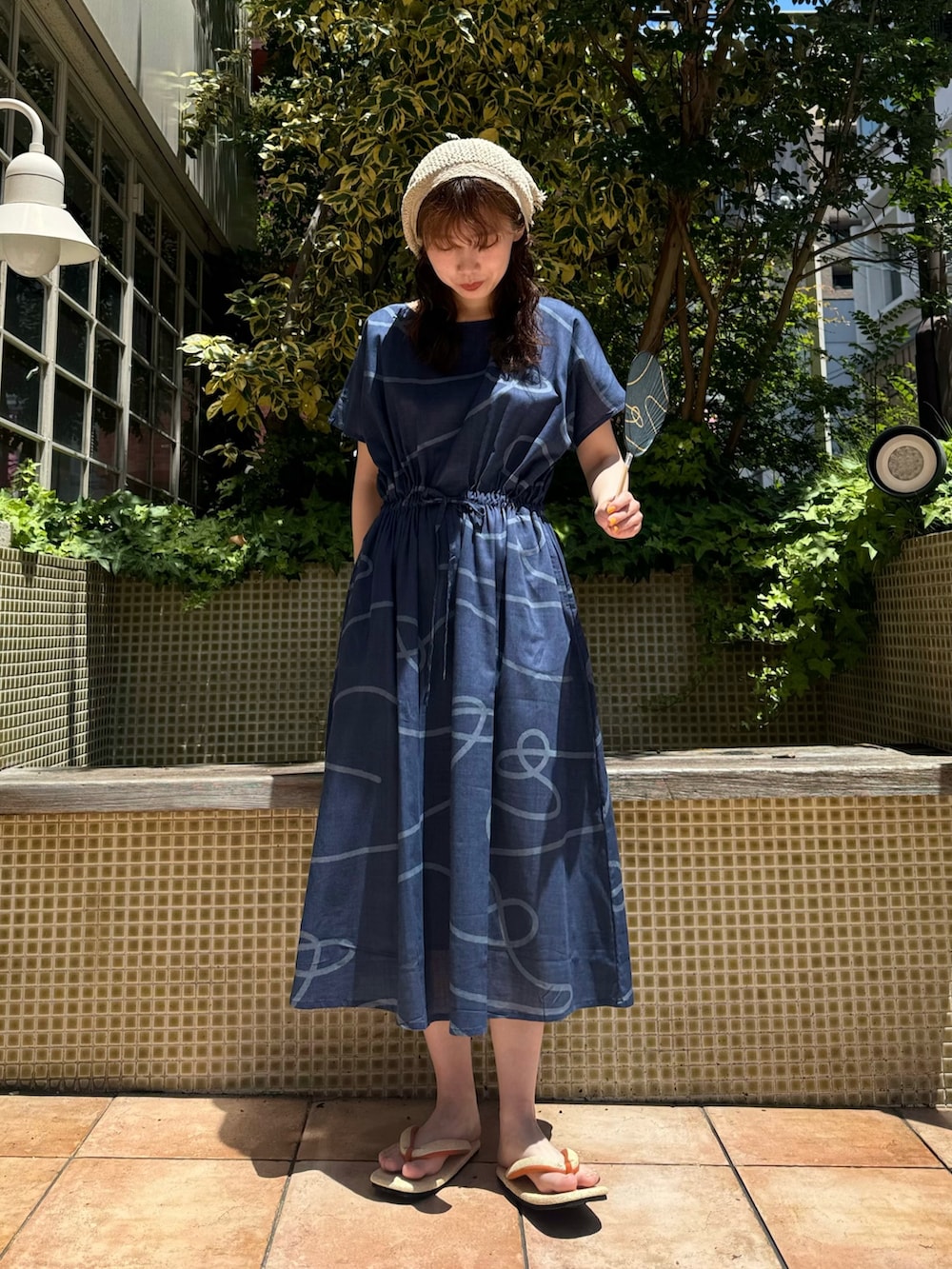 ブルー系のワンピース、ベージュ系のサンダル、ブルー系のその他雑貨を着用したレディースの夏コーディネートの5枚目の写真