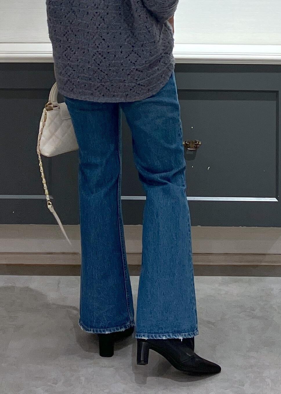 ブラック系のブーツ、ホワイト系のシャツ/ブラウス、ブルー系のニット/セーターを着用したレディースの冬コーディネートの5枚目の写真