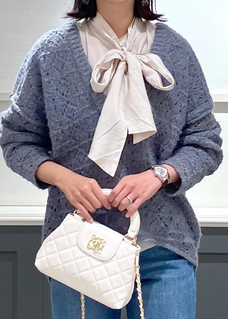 ブラック系のブーツ、ホワイト系のシャツ/ブラウス、ブルー系のニット/セーターを着用したレディースの冬コーディネートの6枚目の写真