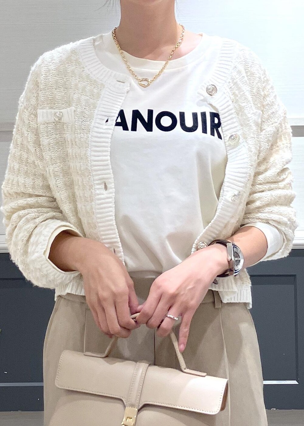 ベージュ系のショルダーバッグ、ブラック系のパンプス、ベージュ系のスラックスを着用したレディースの秋コーディネートの3枚目の写真