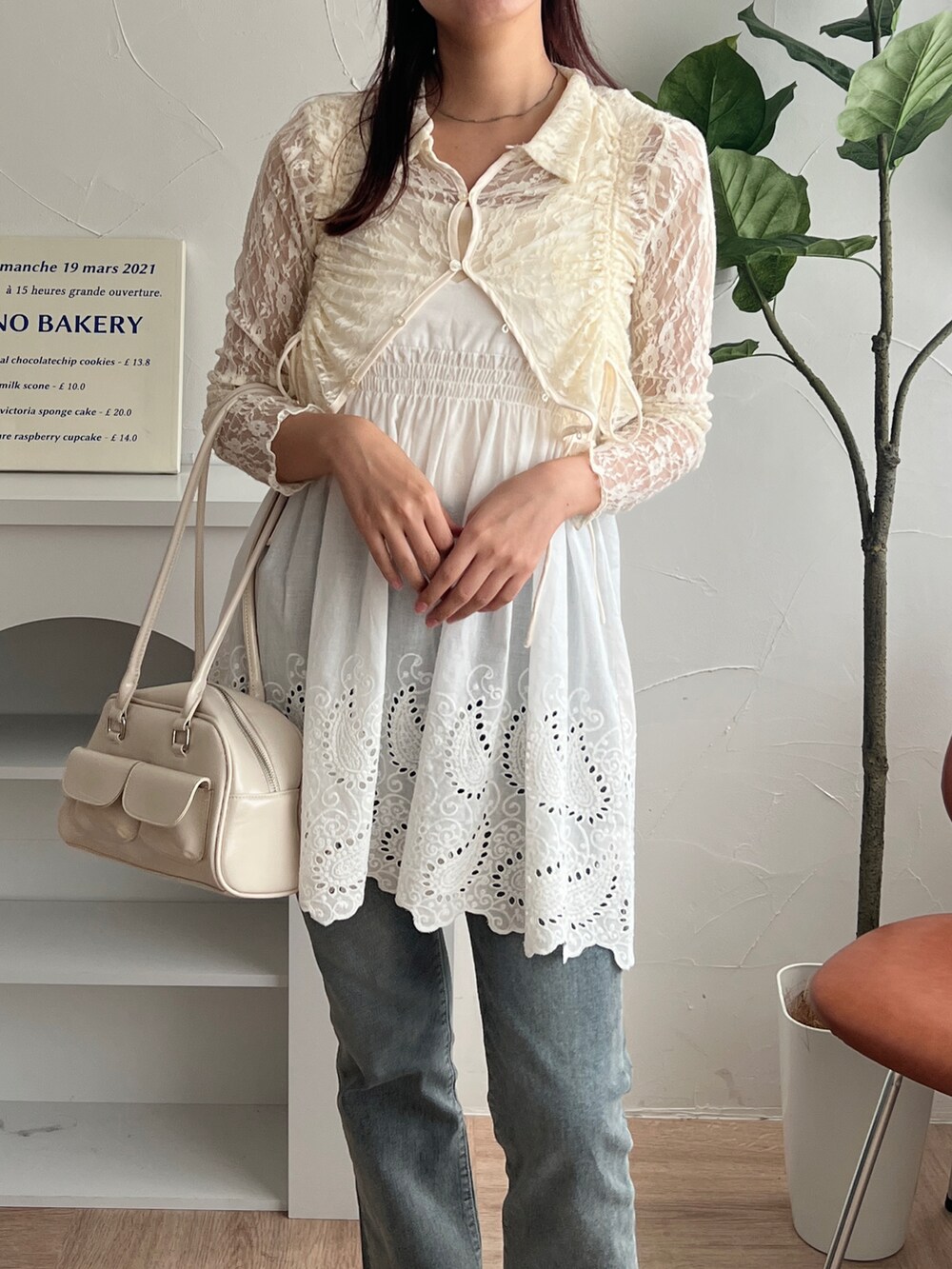 ホワイト系のカーディガン/ボレロ、シルバー系のハンドバッグを着用したレディースの夏コーディネートの2枚目の写真