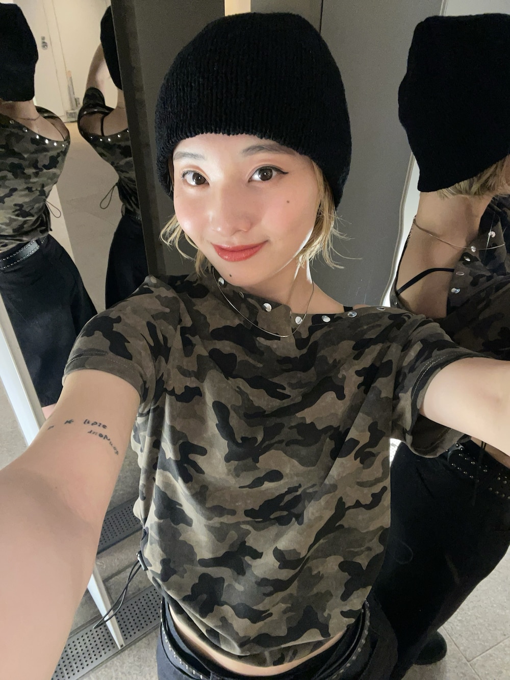 グリーン系のTシャツ/カットソー、ブラック系のニットキャップ/ビーニー、ブラック系のベルトを着用したレディースの春コーディネートの3枚目の写真