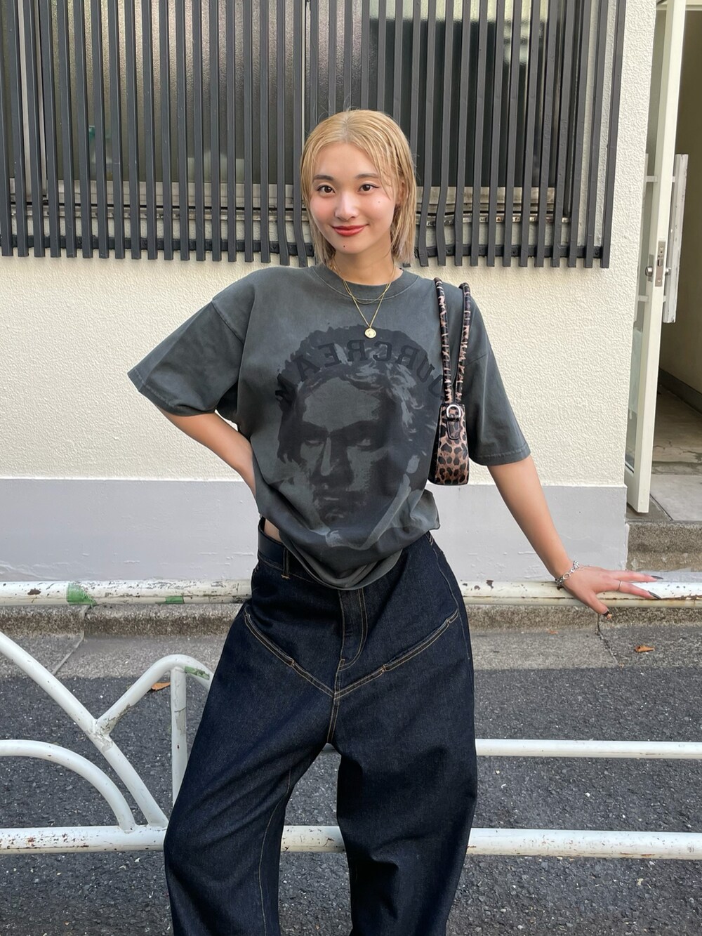 グレー系のTシャツ/カットソー、ブルー系のデニムパンツ、ブラウン系のショルダーバッグを着用したレディースの夏コーディネートの2枚目の写真
