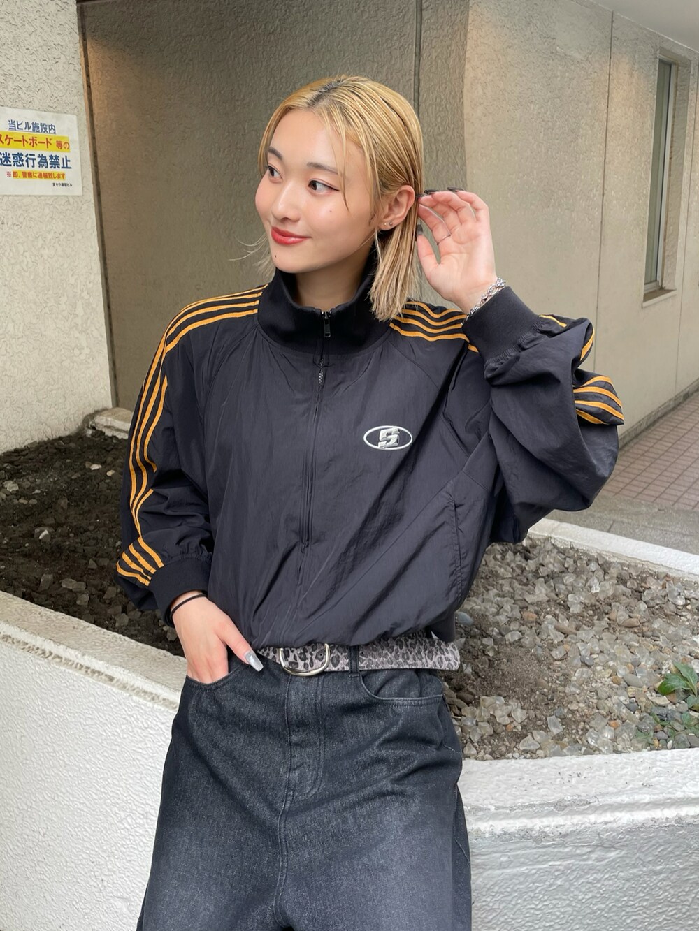 ブラック系のナイロンジャケット、ホワイト系のTシャツ/カットソー、ブラック系のデニムパンツを着用したレディースの夏コーディネートの4枚目の写真