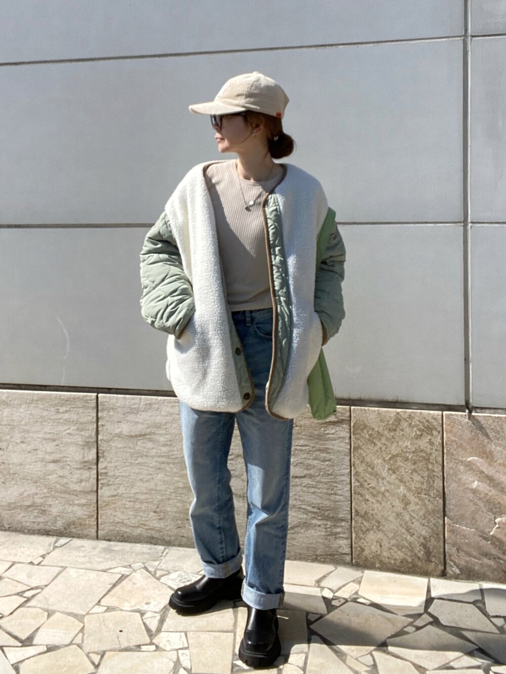 ベージュ系のニット/セーター、ブルー系のパンツ、ブラック系のブーツを着用したレディースの冬コーディネートの3枚目の写真