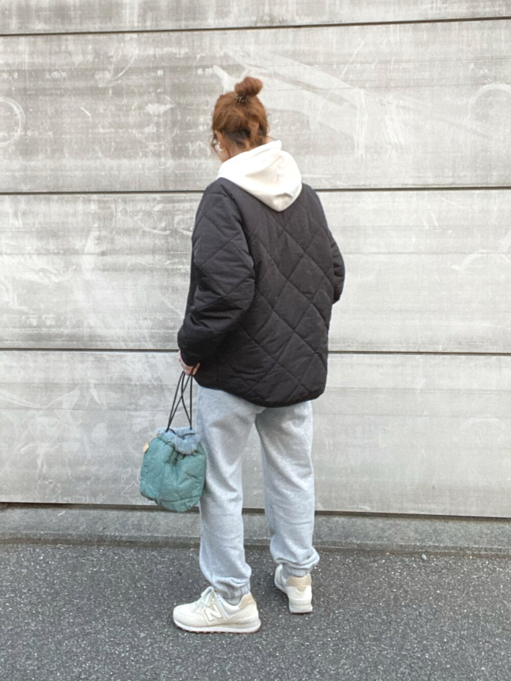 ブラック系のその他アウター、ホワイト系のパーカー、ホワイト系のスニーカーを着用したレディースの冬コーディネートの3枚目の写真