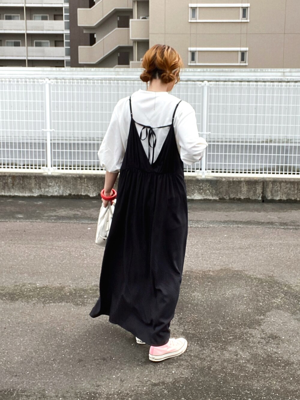 ブラック系のワンピース、ホワイト系のTシャツ/カットソー、ホワイト系のボストンバッグを着用したレディースの春コーディネートの3枚目の写真