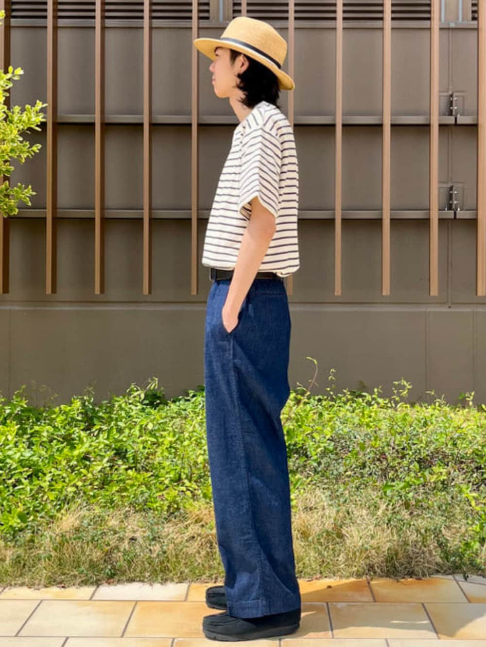 ブルー系のデニムパンツ、ホワイト系のTシャツ/カットソー、ベージュ系のハットを着用したメンズの春コーディネートの2枚目の写真