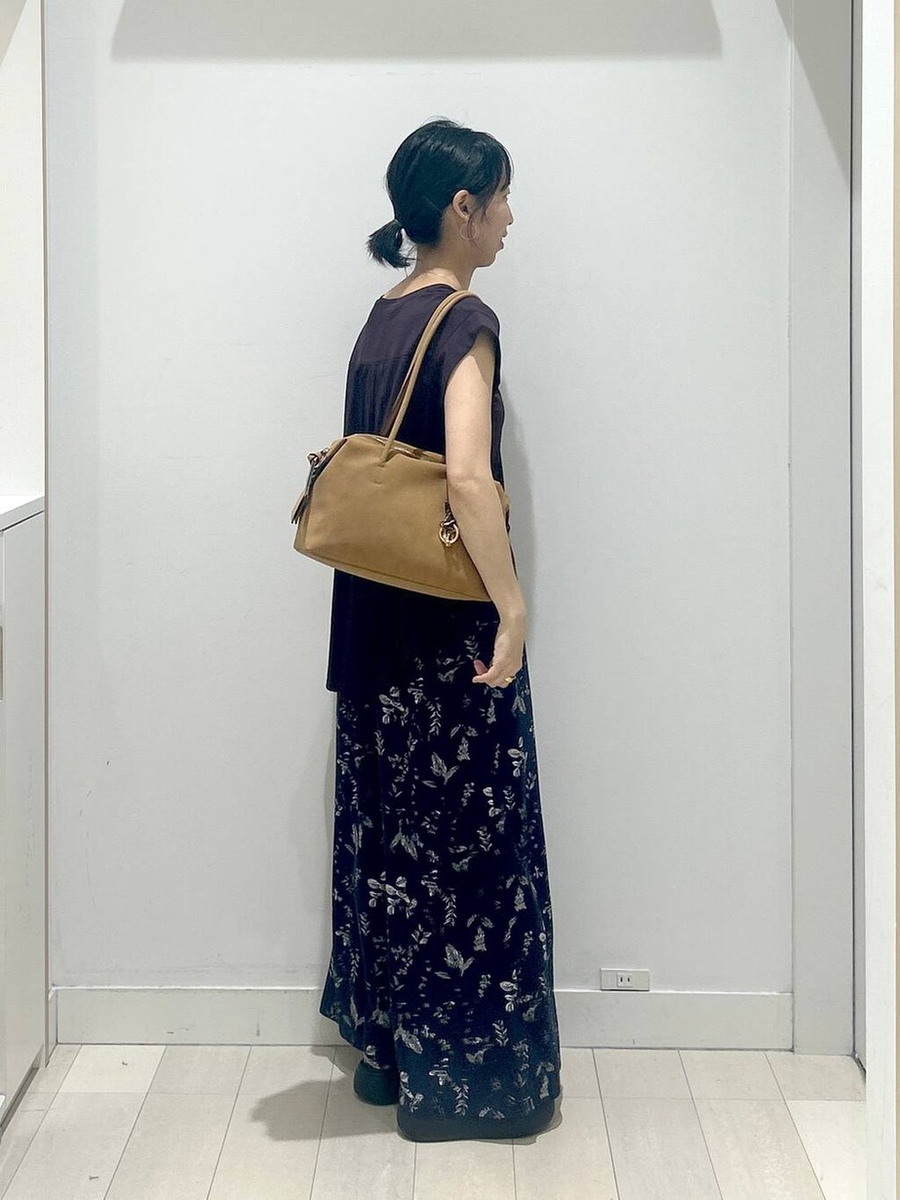 ブラック系のサンダル、ブラウン系のTシャツ/カットソー、ベージュ系のボストンバッグを着用したレディースの夏コーディネートの2枚目の写真