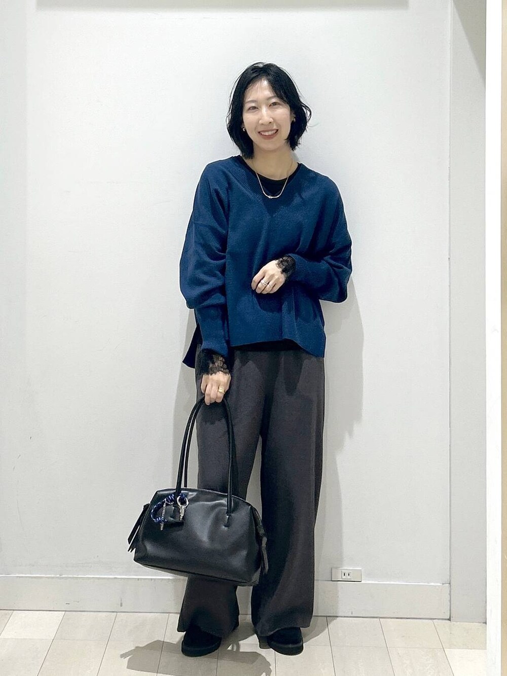 ブラック系のボストンバッグ、ブラック系のローファー、ブラック系のTシャツ/カットソーを着用したレディースの秋コーディネートの5枚目の写真