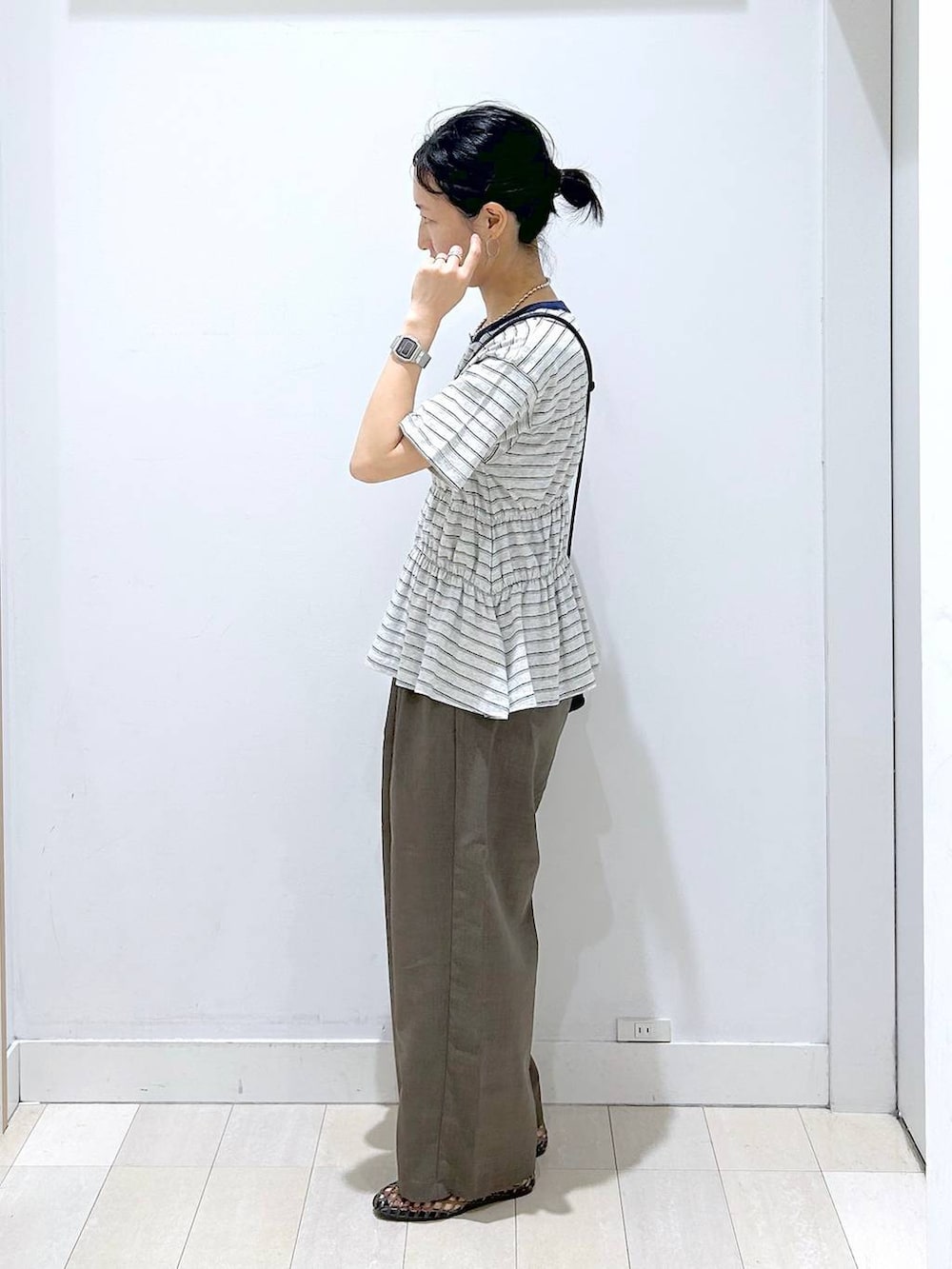 ブラウン系のその他パンツ、ブラック系のサンダル、グレー系のTシャツ/カットソーを着用したレディースの夏コーディネートの2枚目の写真