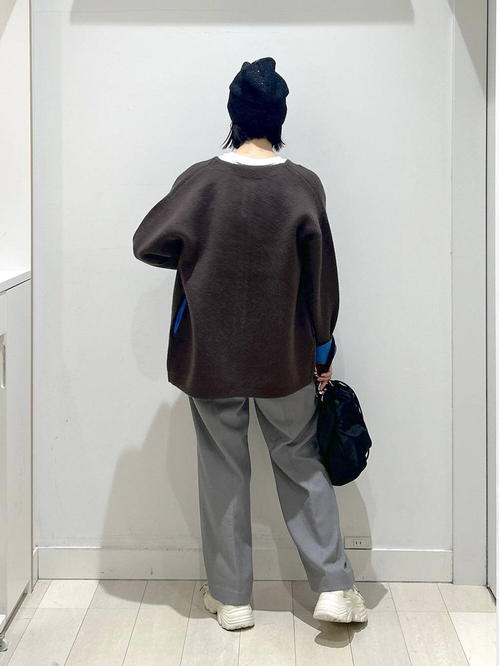 ブラック系のショルダーバッグ、グレー系のその他パンツ、ホワイト系のTシャツ/カットソーを着用したレディースの秋コーディネートの3枚目の写真