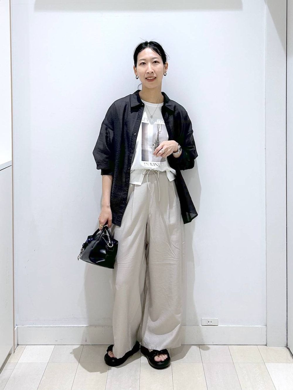 ベージュ系のその他パンツ、グレー系のシャツ/ブラウス、ホワイト系のTシャツ/カットソーを着用したレディースの春コーディネートの5枚目の写真