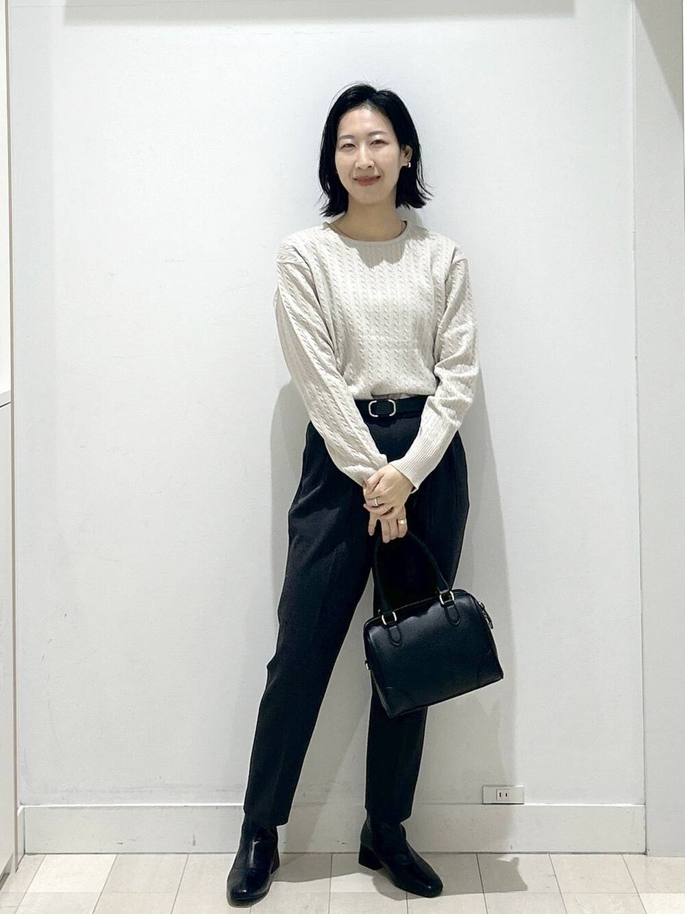 グレー系のその他パンツ、ブラック系のボストンバッグ、ブラック系のブーツを着用したレディースの冬コーディネートの5枚目の写真