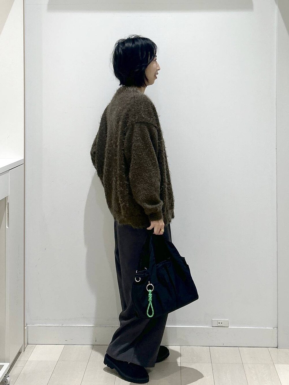 ブラック系のトートバッグ、グレー系のニット/セーター、ブラック系のローファーを着用したレディースの秋コーディネートの2枚目の写真