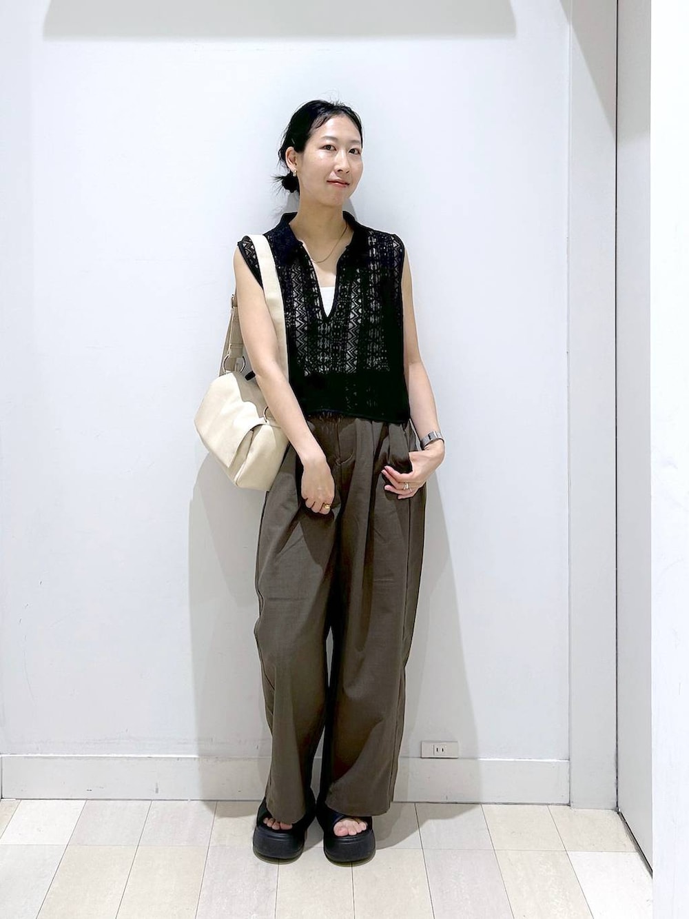 ホワイト系のキャミソール、ブラウン系のその他パンツ、ブラック系のベストを着用したレディースの夏コーディネートの4枚目の写真