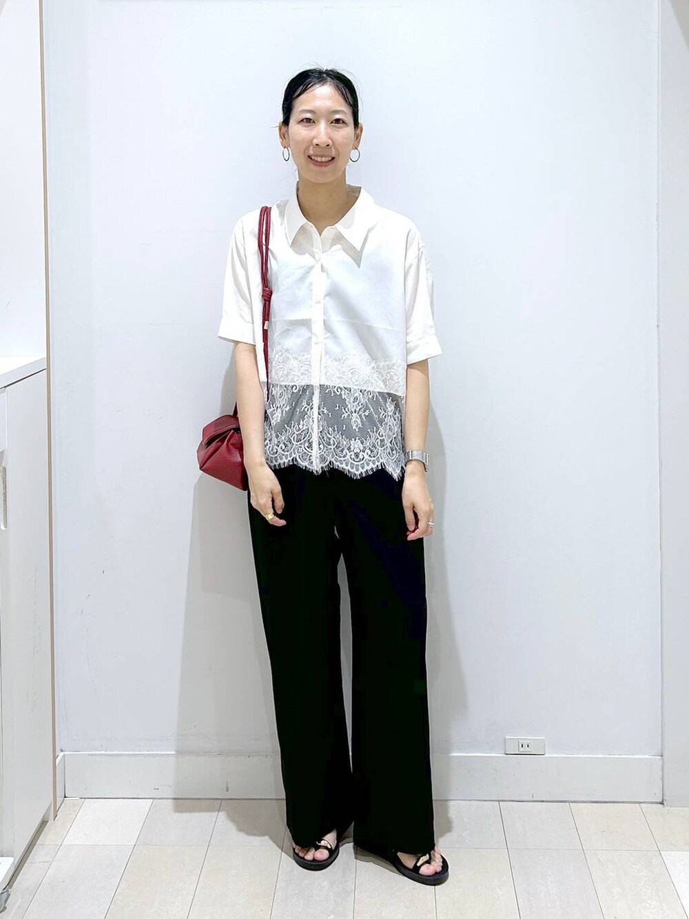 レッド系のショルダーバッグ、ブラック系のその他パンツ、ブラック系のサンダルを着用したレディースの夏コーディネートの5枚目の写真