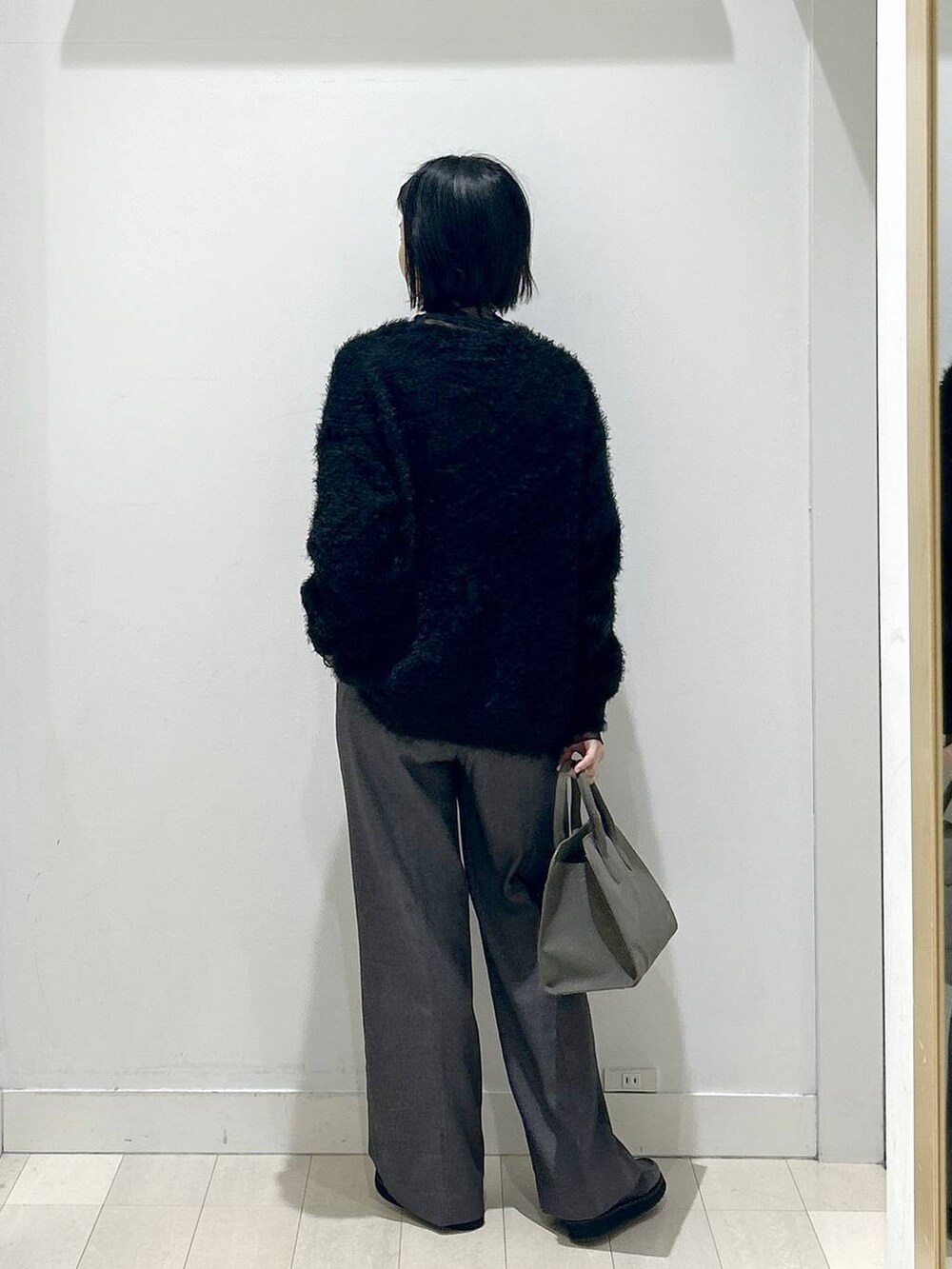 ブラック系のローファー、グレー系のその他パンツ、グリーン系のショルダーバッグを着用したレディースの秋コーディネートの3枚目の写真