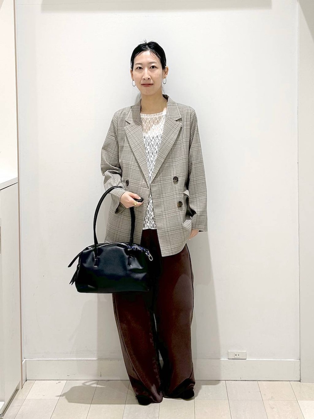 ブラック系のローファー、ブラック系のボストンバッグ、ブラウン系のスウェットパンツを着用したレディースの春コーディネートの5枚目の写真