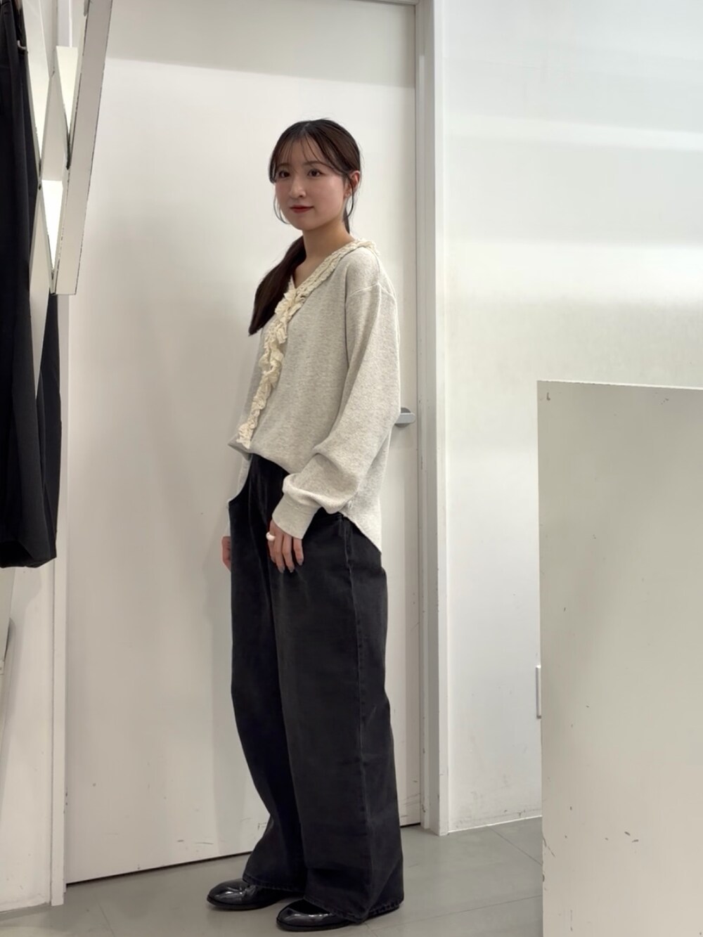 ブラック系のデニムパンツ、ブラック系のローファー、ベージュ系のTシャツ/カットソーを着用したレディースの春コーディネートの2枚目の写真