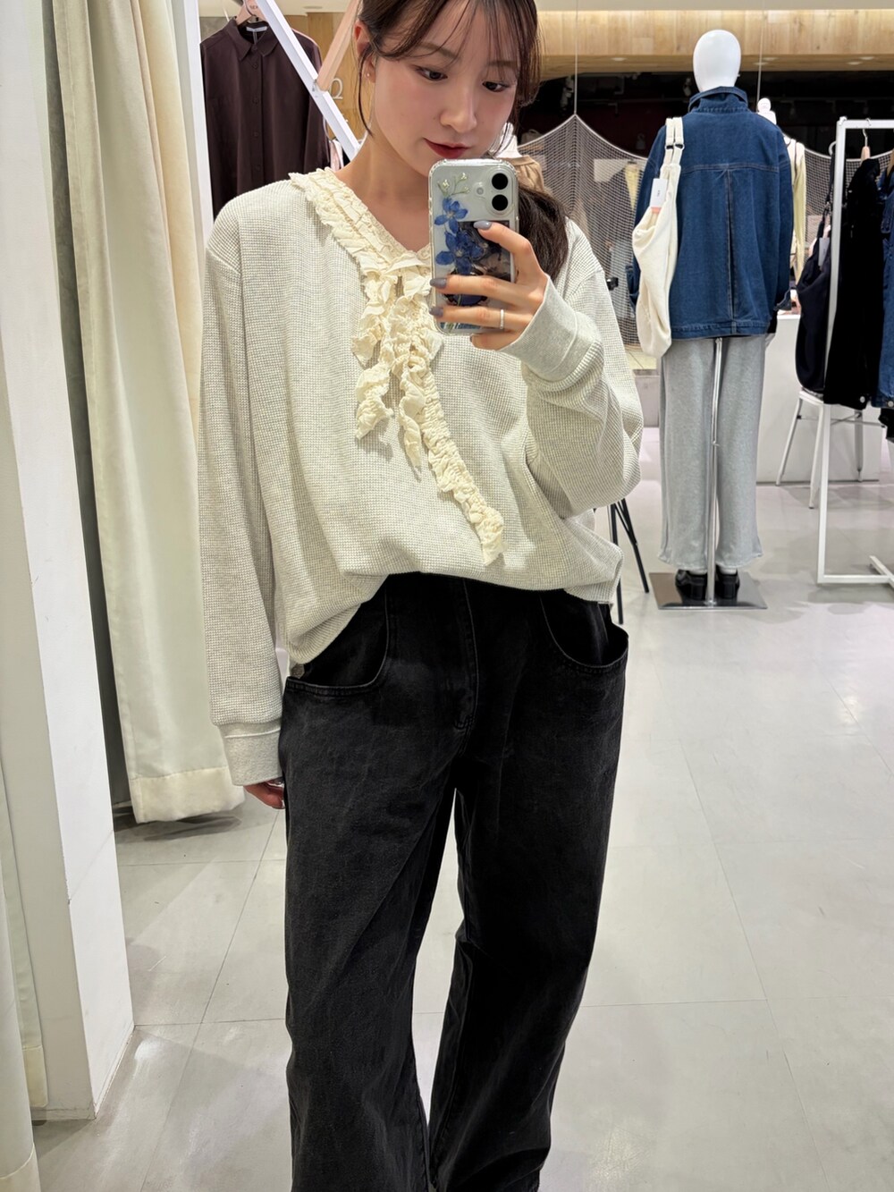 ブラック系のデニムパンツ、ブラック系のローファー、ベージュ系のTシャツ/カットソーを着用したレディースの春コーディネートの5枚目の写真